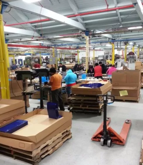 Assembly floor with workers and packed orders